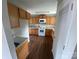 Bright kitchen features wood cabinets, white appliances, and wood-look floors at 118 Steam Engine Dr # 201, Mooresville, NC 28115