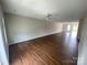 Expansive living room featuring hardwood floors and natural light streaming through the windows at 118 Steam Engine Dr # 201, Mooresville, NC 28115