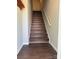 Stairway with modern flooring and white railing leading to the upper level at 118 Steam Engine Dr # 201, Mooresville, NC 28115