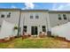 Backyard patio with seating, string lights, fenced yard and grassy area at 12021 Basking Dr, Charlotte, NC 28214