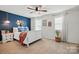 Cozy bedroom with a navy accent wall, stylish decor, and natural light from two windows at 12021 Basking Dr, Charlotte, NC 28214