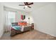 Cozy bedroom with a twin bed, soft carpet, and a ceiling fan for comfort at 12021 Basking Dr, Charlotte, NC 28214