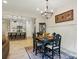 Open dining area with a decorative chandelier, stylish table set, and a view into the kitchen at 12021 Basking Dr, Charlotte, NC 28214