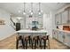 Bright kitchen with light gray cabinets, a large island with seating, and stainless steel appliances at 12021 Basking Dr, Charlotte, NC 28214