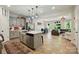 Open kitchen with stainless steel appliances, center island, and seamless flow into the living area at 12021 Basking Dr, Charlotte, NC 28214