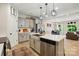 Spacious kitchen with light gray cabinets, stainless steel appliances, island, and an adjacent dining area at 12021 Basking Dr, Charlotte, NC 28214