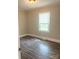 Small bedroom features wood-look flooring, neutral paint, and a bright window at 1336 Norris Ave, Charlotte, NC 28206