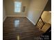 Bedroom features wood-look flooring, neutral paint, and a bright window at 1336 Norris Ave, Charlotte, NC 28206