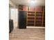 Kitchen features wood-look flooring, neutral paint, black appliances, and a bright window at 1336 Norris Ave, Charlotte, NC 28206