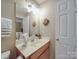 Bathroom with neutral colors, a wood vanity, and modern mirror and lights at 135 Henry Putnam Dr, Cherryville, NC 28021