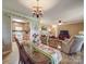 Open-concept dining area with hardwood floors, a chandelier, and seamless transition to the living room and kitchen at 135 Henry Putnam Dr, Cherryville, NC 28021