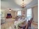 Well-lit dining area with a wooden table, chandelier, and access to the living room at 135 Henry Putnam Dr, Cherryville, NC 28021
