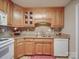 Beautiful kitchen featuring light wood cabinets, a stone backsplash, and stainless steel sink at 135 Henry Putnam Dr, Cherryville, NC 28021