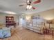 Bright living room with hardwood floors, ceiling fan, tan sofas, and seamless view into dining area at 135 Henry Putnam Dr, Cherryville, NC 28021