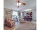 Open living room with hardwood floors, neutral walls, a recliner, and a view into the dining area at 135 Henry Putnam Dr, Cherryville, NC 28021