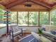 Inviting sunroom with wood ceiling, comfortable seating, and large windows overlooking the backyard at 135 Henry Putnam Dr, Cherryville, NC 28021