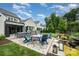 Backyard features outdoor kitchen, fire pit, dining area, and garden at 13602 Huntson Park Ln, Huntersville, NC 28078