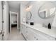Elegant bathroom with double vanity, stylish mirrors, and neutral color scheme at 13602 Huntson Park Ln, Huntersville, NC 28078