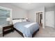 Spacious bedroom featuring a large bed and a glimpse into the bathroom at 13602 Huntson Park Ln, Huntersville, NC 28078