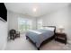 Cozy bedroom with a bed, a chair and plenty of natural light at 13602 Huntson Park Ln, Huntersville, NC 28078