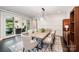 Bright dining room with stylish furniture, area rug, and sliding glass doors to the outdoor living area at 13602 Huntson Park Ln, Huntersville, NC 28078