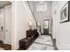 Elegant home entryway featuring a staircase, stylish light fixtures, and hardwood floors with an area rug at 13602 Huntson Park Ln, Huntersville, NC 28078