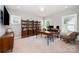 Bright office space with built-in shelving, desk, and ample natural light at 13602 Huntson Park Ln, Huntersville, NC 28078