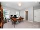 Well-lit home office featuring hardwood desk and neutral color scheme at 13602 Huntson Park Ln, Huntersville, NC 28078