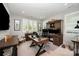 This home office features custom built ins, light gray walls, a large desk, and plantation shutters at 13602 Huntson Park Ln, Huntersville, NC 28078