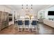 Beautiful kitchen with a large island with seating, stainless steel appliances, and elegant pendant lighting at 13602 Huntson Park Ln, Huntersville, NC 28078