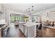 Open kitchen layout with stainless steel appliances, a center island, and seamless flow to the living and dining areas at 13602 Huntson Park Ln, Huntersville, NC 28078