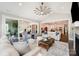 Open concept living room with large windows, vaulted ceilings, and access to the outdoor patio at 13602 Huntson Park Ln, Huntersville, NC 28078