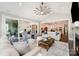 Open concept living room with large windows, vaulted ceilings, and access to the outdoor patio at 13602 Huntson Park Ln, Huntersville, NC 28078