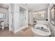 This main bathroom has a glass shower, soaking tub, double sinks and tile floor at 13602 Huntson Park Ln, Huntersville, NC 28078