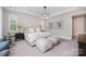 This main bedroom features a plush carpet, a large window and stylish decor at 13602 Huntson Park Ln, Huntersville, NC 28078