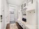 This mudroom features a bench with storage space, hooks, and hardwood floors at 13602 Huntson Park Ln, Huntersville, NC 28078