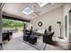 Cozy outdoor living area features a ceiling fan, comfortable seating, and views of the landscaped backyard at 13602 Huntson Park Ln, Huntersville, NC 28078