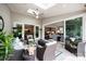 Inviting outdoor living space with stylish furniture, a ceiling fan, and a seamless connection to the home's interior at 13602 Huntson Park Ln, Huntersville, NC 28078