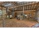 Interior shot of barn featuring stalls, equipment, and a rustic, wooden aesthetic at 140 Hearthstone Dr, Statesville, NC 28677