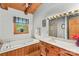 Bright bathroom showcasing a soaking tub, vanity, and natural light at 140 Hearthstone Dr, Statesville, NC 28677
