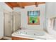 Bathroom featuring a soaking tub and a separate glass-enclosed shower at 140 Hearthstone Dr, Statesville, NC 28677