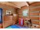 Unique bedroom featuring wood walls, neutral-colored floor, and vintage furnishings at 140 Hearthstone Dr, Statesville, NC 28677