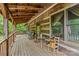 Relaxing covered porch with wooden floors, seating, and a charming rustic ambiance at 140 Hearthstone Dr, Statesville, NC 28677