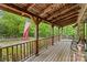 Spacious covered porch with beautiful wood detailing and scenic views of the surrounding greenery at 140 Hearthstone Dr, Statesville, NC 28677