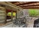 Cozy outdoor deck with seating area and view of the surrounding woods at 140 Hearthstone Dr, Statesville, NC 28677