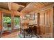 Charming dining room with wooden walls, a chandelier, and access to a covered deck at 140 Hearthstone Dr, Statesville, NC 28677