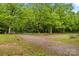 Gravel driveway with a circular turnaround and garden features at 140 Hearthstone Dr, Statesville, NC 28677
