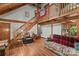 Bright living room with hardwood floors, an open staircase, and plenty of natural light at 140 Hearthstone Dr, Statesville, NC 28677