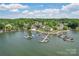 Amazing aerial view of a lakefront condo community with private docks and beach area at 14118 Yachtsman Harbor Dr, Charlotte, NC 28278