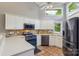 Bright kitchen featuring white cabinets, stainless steel appliances, tiled floors and a large window at 14118 Yachtsman Harbor Dr, Charlotte, NC 28278